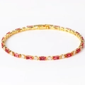 Detail of gold tennis bracelet featuring alternating red and clear cubic zirconia stones - Rose Red Zircon Gold