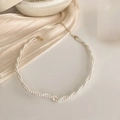 Macro detail of twisted pearl necklace featuring a sparkling rhinestone and gold clasp - Necklace - Gold Tone Pearl