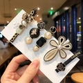 Detail of 5-piece gold and black hair clip set with pearls and metal bear charms - Black Bear 5-Piece Set