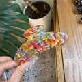 Close-up of a large acetate claw clip with colorful floral pattern and smooth finish - Large