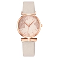 Women's quartz watch with beige leaf pattern dial, bow charm, and white leather strap - Beige