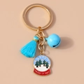 Close-up of Christmas keychain with blue tassel, bell, and a festive snow globe charm - Blue Christmas Crystal Ball