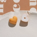 Close-up of heart-shaped resin beads in amber and white for DIY jewelry making - Orange Heart