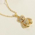 Macro shot of gold-plated bear pendant with sparkling zircon micro-pave detailing - Overalls Bear