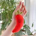 Macro shot of red chili plush keychain with metal ring and embroidered angry expression - Chili Style with Gold Clasp