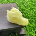 Pale green semi-precious stone dragon head sculpture on dark wood stand, 1.5 inches - Afghan Jade