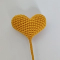 Handmade crochet heart bouquet in ginger yellow yarn on a white background - Orange