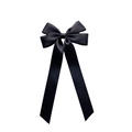 Detalle de elegante lazo de satén negro para el pelo con cintas largas y textura de seda - Negro