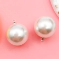 Spherical white pearl pendant charms with silver metal rings on a pink background - 20mm Silver Round