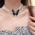 Multi-layer pearl necklace featuring a large blue gradient butterfly pendant on model - Four-Layer Artificial Pearl Blue Butterfly Pendant Necklace (X4203B)