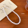 French vintage necklace with 12mm white pearl and gold clasp on a wooden desk - 12mm Pearl