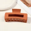 Detail of large matte orange hair claw clip with hollow rectangle design on ceramic dish - 10.5cm Rectangular - Matte Orange