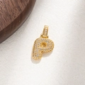 Detailed close-up of sparkling gold-plated letter P pendant with micro-pave crystals - Letter P
