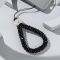 Detail of beaded phone strap with black faceted beads and sparkling rhinestone ball charm - Black