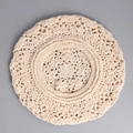 Detailed close-up of handmade crochet hollow floral pattern on a cream beret hat - Beige
