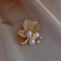 Golden leaf brooch with white pearls and small diamonds on beige fabric background - Leaf Style (X0262)