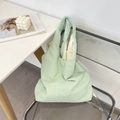 Detail of mint green tote bag featuring unique bubble pleated texture and sturdy strap - Light Green