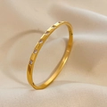 Elegant gold titanium steel bracelet with sparkling zircons on soft satin background - Gold