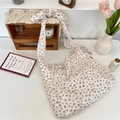 Detail of floral canvas tote bag showing wide knotted shoulder strap and vintage flower patterns - Floral Tie Strap Crossbody Bag