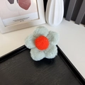 Cute plush flower hair claw clip in sage green and orange fur for autumn hairstyles - Green with Orange Center