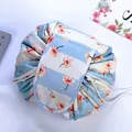 Blue and white striped drawstring makeup bag with pink floral patterns and flap - Daisy