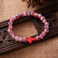 Handmade beaded bracelet with red cross charm and colorful splatter pattern beads - Red White Blue Splatter Red Cross