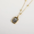 Vintage 18K gold plated necklace with black rectangular floral pendant on white background - November Chrysanthemum