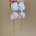Detail of white 3D flower petal earrings with long gold chain tassels on card - White Flower Tassel Style / White
