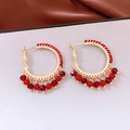 Detail of red beaded glass fringe and gold metal ring in a retro ethnic style earring - Silver Needle / Gold Red