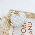 White heart-shaped quilted girls' bag with large pearl strap and gold floral zipper pull - White