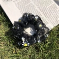 Daisy pattern black mesh scrunchie hair tie on grass and newspaper background - Black Mesh Daisy