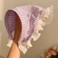 Detail of baby sun hat with purple gingham pattern and white ruffled lace trim edges - Purple Plaid