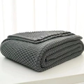 Dark gray chunky knit blanket with Nordic fringe, neatly folded in a cozy minimalist style - Gray