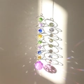 3D spinning wind chime showing colorful crystals reflecting rainbow prism light effects - Purple