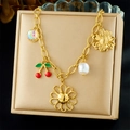 Detail of gold-plated bracelet with cherry, sunflower and pearl charms on soft cushion - Cherry Daisy Pearl Multi-charm Style(N3722)