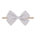 Detailed view of grey linen bow on beige nylon headband for babies and infants - Gray