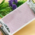 Detailed view of pink self-adhesive acrylic rhinestones arranged in a neat grid for DIY - 4mm / Pink