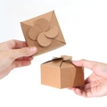 Square kraft paper gift box featuring a unique four-petal floral folding closure design - Kraft Color