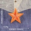Orange star embroidery patch measuring 2.9cm with self-adhesive backing for apparel - Orange