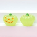 Detail of two translucent green glowing pumpkin figurines for Halloween DIY decor - Luminous Green (Yellow Expression)