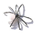 Macro view of spider sculpture made of dark metal and natural rose quartz crystal - Oval Rose Quartz