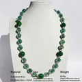 Handmade green glass beaded necklace with gold-plated brass on a white jewelry bust - Handmade Lampwork Mid-length Necklace / Emerald Green Texture