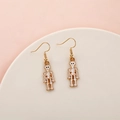 Halloween drop earrings featuring white skeleton charms and gold-toned metal hooks - Skeleton Bone Structure
