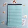 Minimalist light blue legal pad with horizontal lines and black tape binding on top - Blue