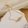 Goldenes Evil-Eye-Armband mit blauen Zirkonia auf dekorativem weißem Steinsockel - Gold-Dunkelblau (31700)