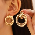 Exaggerated geometric gold twisted hoop earrings for women in minimalist style - Smooth Multi-Ring Overlapping (9076)