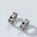 Close-up of silver stainless steel earrings with I Love U heart pattern and polished finish - I Love You Style
