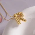 Minimalist gold balloon letter R pendant necklace with polished finish on fine chain - Letter R