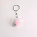 Close-up of a pink bubble tea keychain with realistic black pearls and striped straw - Pink