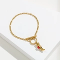 Close-up of golden Figaro chain bracelet with red horn pendant and toggle clasp closure - Horn Pendant / Gold